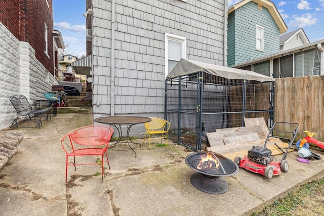 view of patio with an outbuilding and an outdoor fire pit