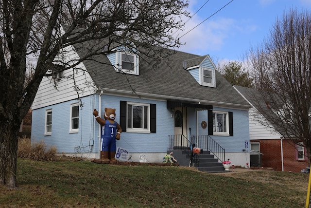 new england style home featuring a front lawn