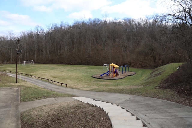 view of playground with a lawn