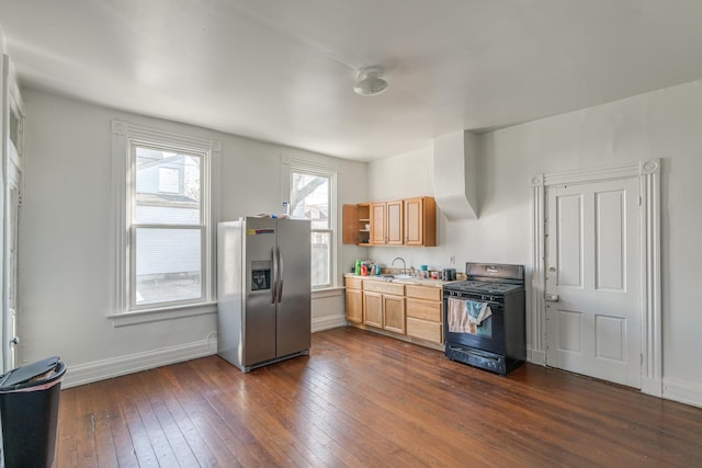 kitchen with black gas range oven, stainless steel fridge with ice dispenser, dark hardwood / wood-style flooring, and sink