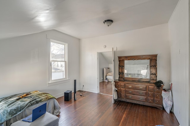 bedroom with lofted ceiling and dark hardwood / wood-style floors