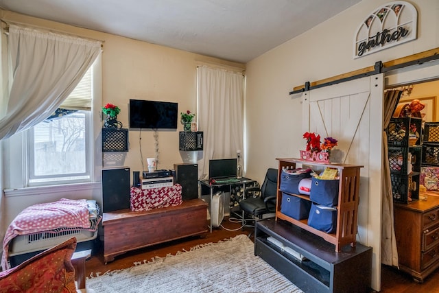 sitting room with hardwood / wood-style floors and a barn door