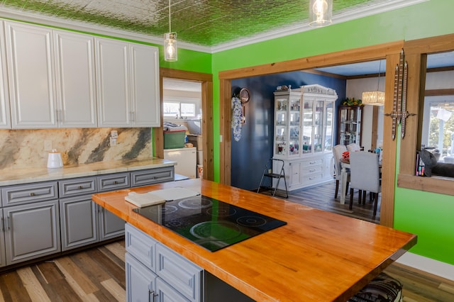 kitchen with pendant lighting, gray cabinetry, wooden counters, ornamental molding, and black electric cooktop