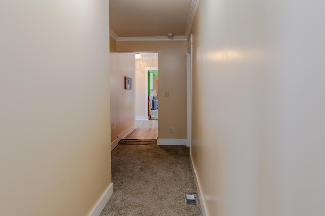 hallway featuring crown molding and light carpet