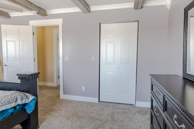 bedroom featuring light carpet, ornamental molding, and beamed ceiling