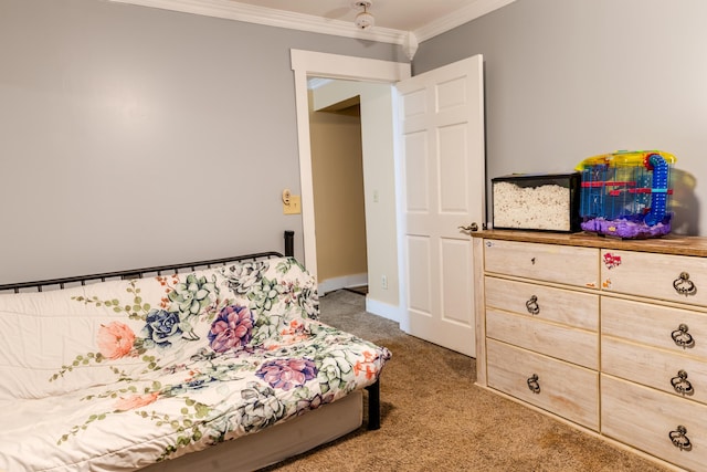 bedroom with ornamental molding and carpet