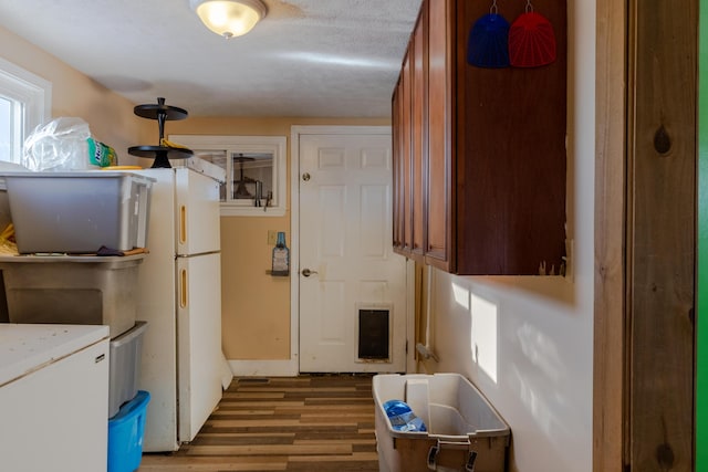 kitchen featuring dark wood-type flooring and white fridge