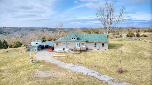 view of front of home with an outbuilding, a carport, and a front lawn