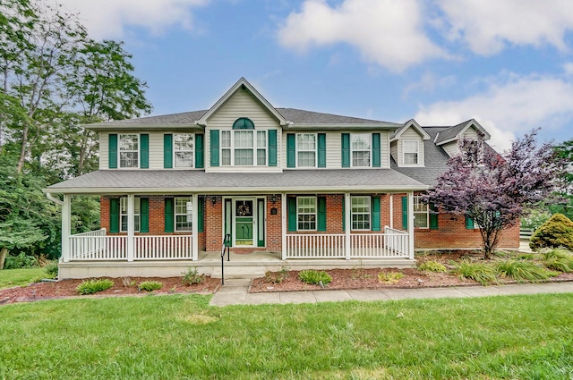 view of front of property featuring a front lawn and a porch