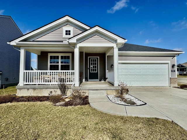 view of front of house with a porch, a garage, and a front yard