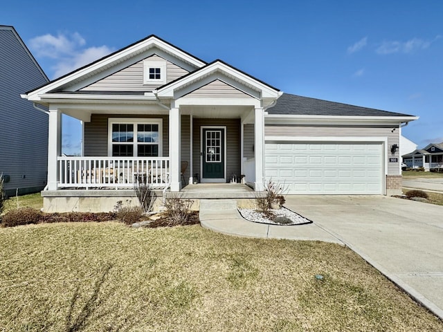 view of front facade featuring a porch, a garage, and a front yard