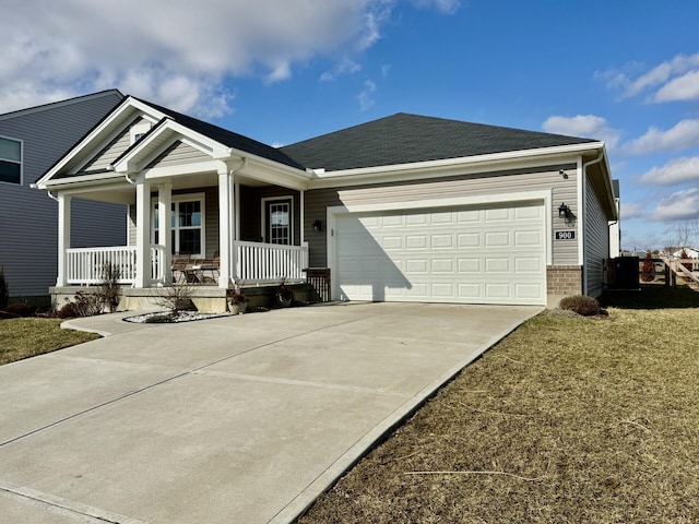 view of front facade featuring a porch, a garage, a front lawn, and central air condition unit