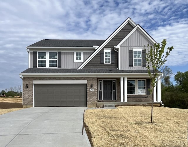 craftsman house featuring a garage, board and batten siding, concrete driveway, and a porch