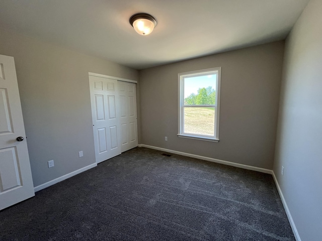 1703 Barons Cv, Hebron, KY 41048 - unfurnished bedroom with dark colored carpet, baseboards, and a closet