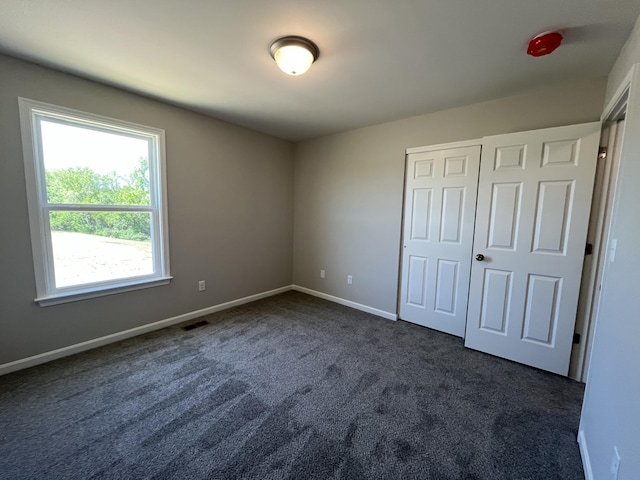 1703 Barons Cv, Hebron, KY 41048 - unfurnished bedroom featuring dark colored carpet, baseboards, and a closet