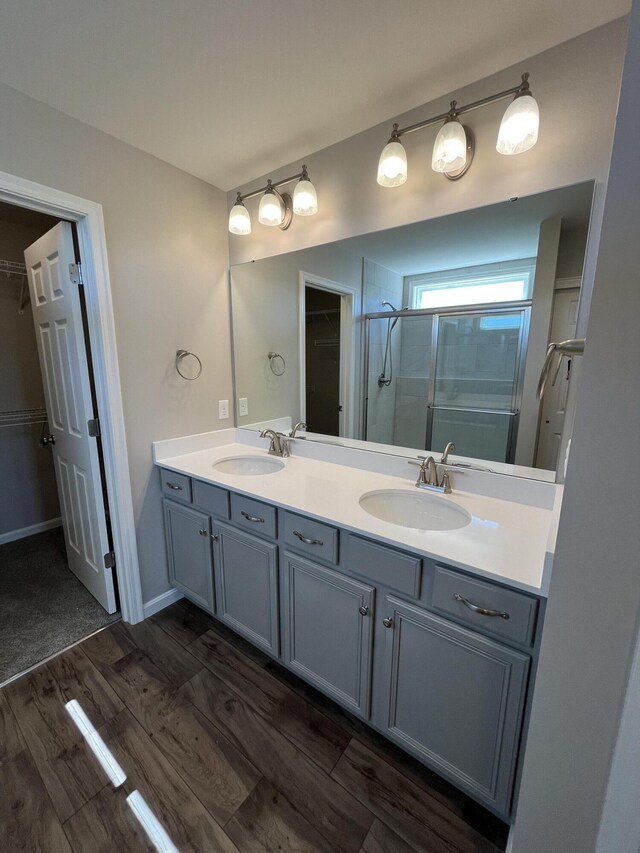 1703 Barons Cv, Hebron, KY 41048 - full bathroom with wood finished floors, a walk in closet, a stall shower, and double vanity