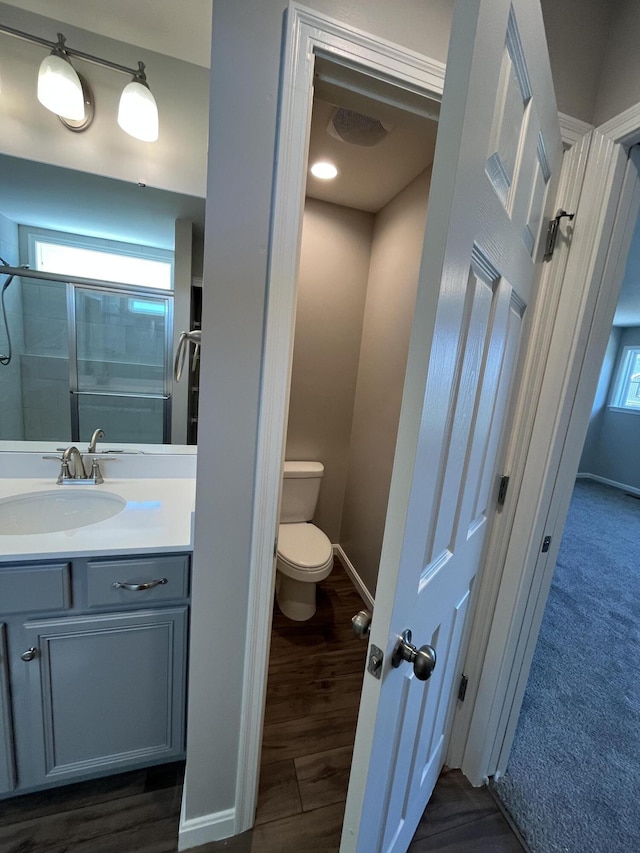 1703 Barons Cv, Hebron, KY 41048 - full bathroom with vanity, toilet, baseboards, and wood finished floors