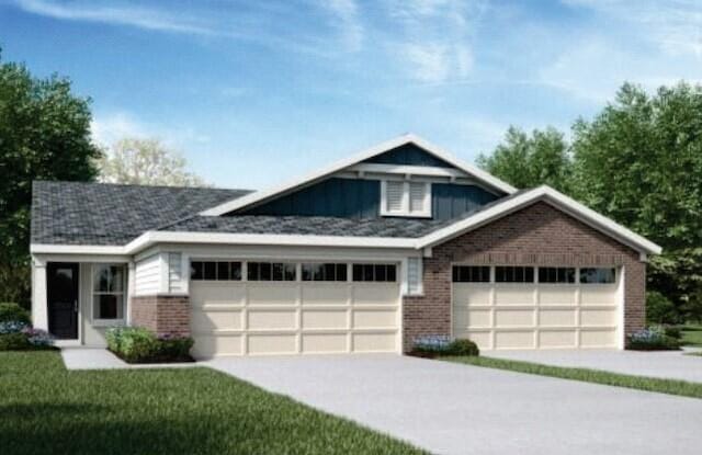 1317 Parkside Dr Unit 168A, Alexandria, KY 41001 - view of front facade featuring an attached garage, concrete driveway, brick siding, board and batten siding, and a front yard