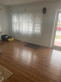 spare room with dark hardwood / wood-style flooring