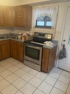 kitchen with light tile patterned flooring and stainless steel electric stove