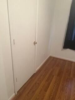 unfurnished bedroom featuring dark wood-type flooring