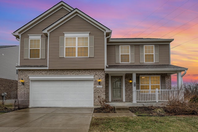 view of front of property featuring a garage and covered porch