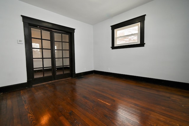 unfurnished room featuring french doors and dark hardwood / wood-style flooring