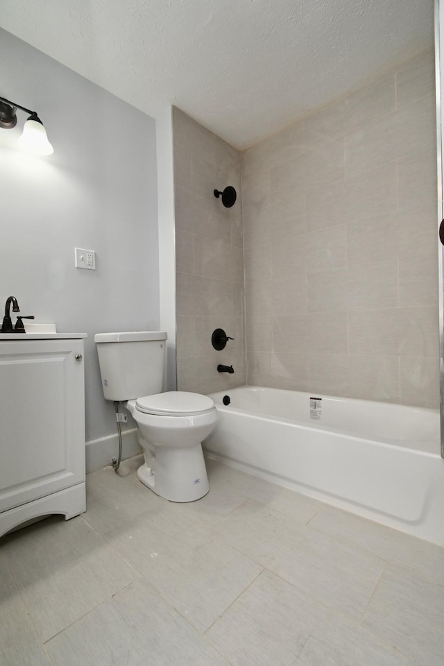 full bathroom with vanity, a textured ceiling, tiled shower / bath combo, tile patterned flooring, and toilet