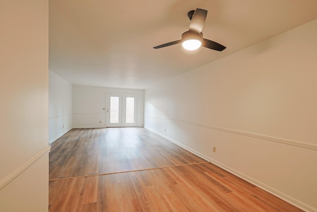 unfurnished room featuring hardwood / wood-style flooring, ceiling fan, and french doors