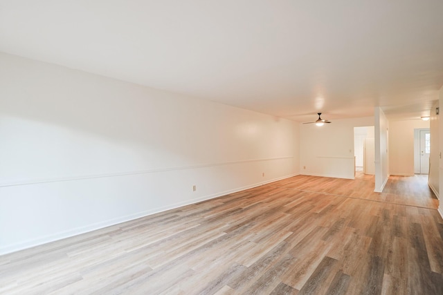 empty room featuring ceiling fan and light hardwood / wood-style flooring