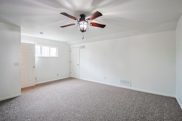 unfurnished room with ceiling fan, lofted ceiling, and carpet