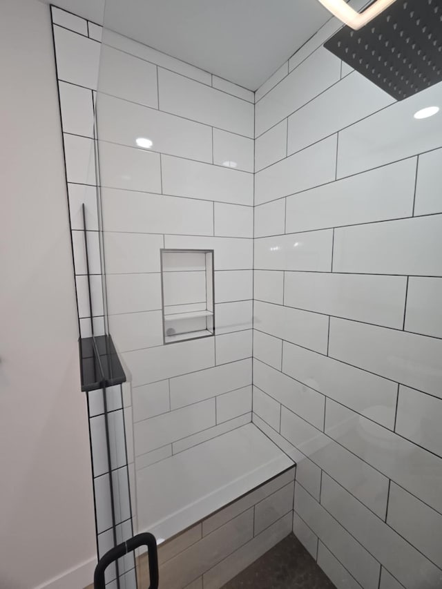 bathroom with a tile shower