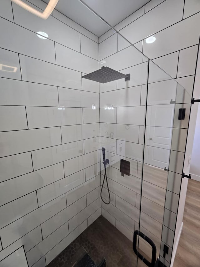 bathroom featuring an enclosed shower and hardwood / wood-style floors