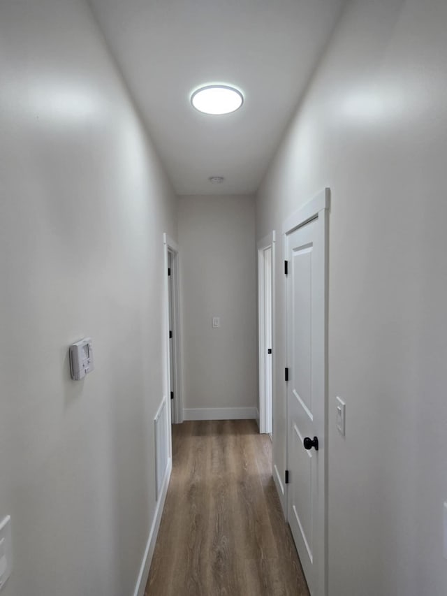 corridor featuring dark hardwood / wood-style flooring