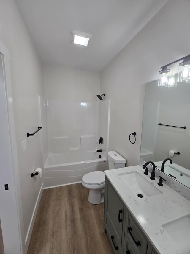 full bathroom with hardwood / wood-style flooring, vanity, toilet, and shower / bathing tub combination