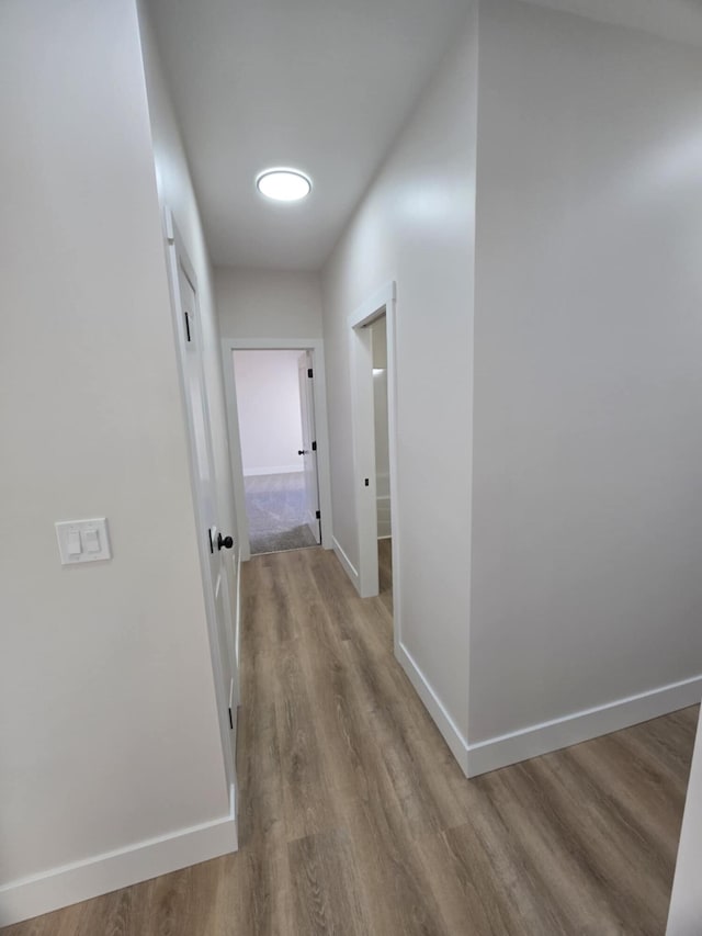 corridor with light wood-type flooring