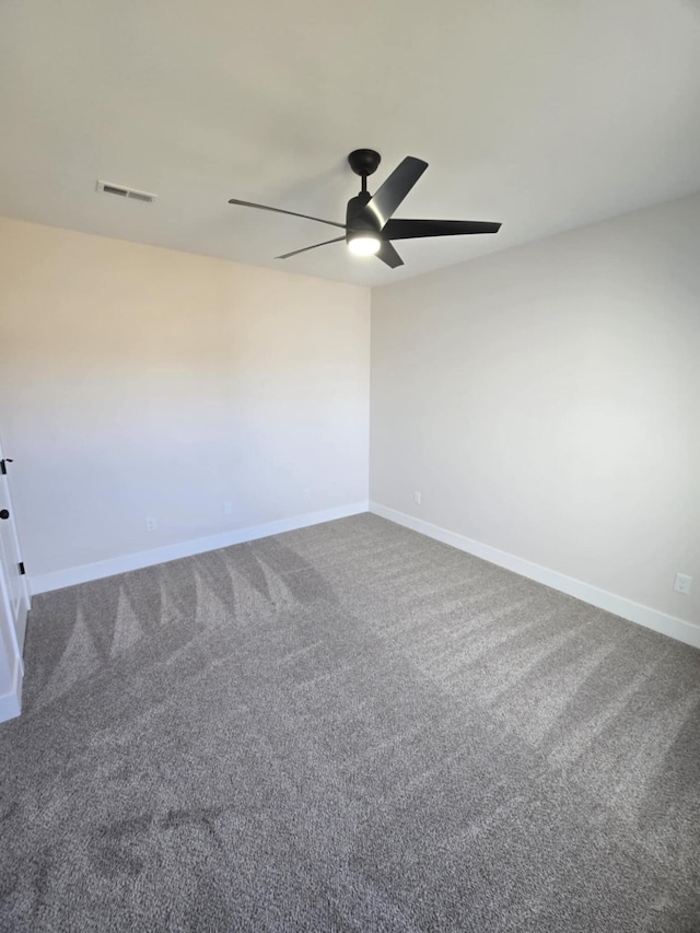 unfurnished room featuring ceiling fan and carpet floors