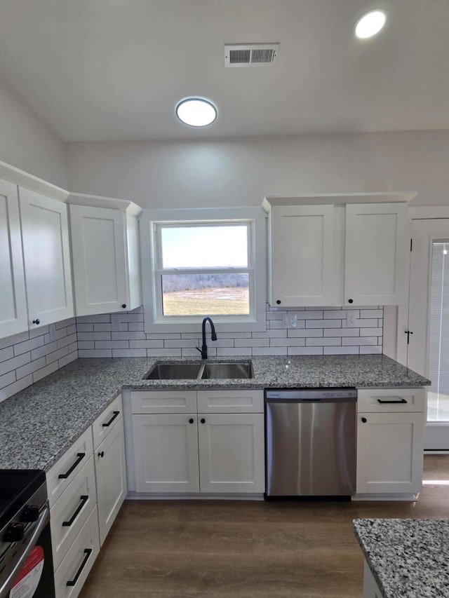 kitchen with appliances with stainless steel finishes, sink, and white cabinets