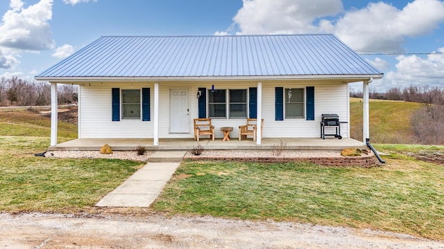 bungalow-style home with a front yard and covered porch