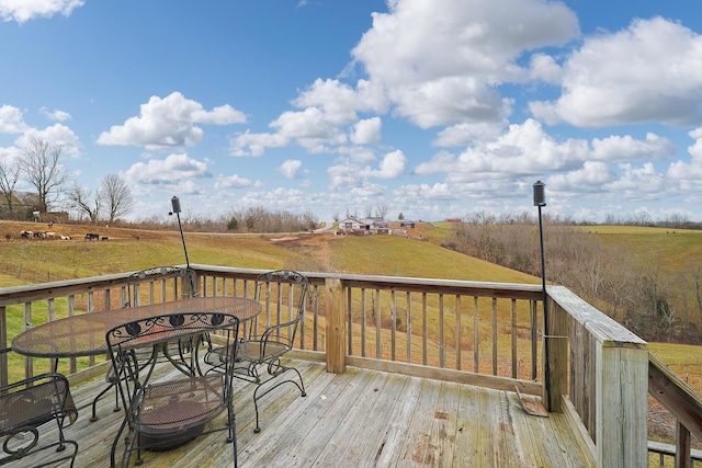 deck featuring a lawn and a rural view