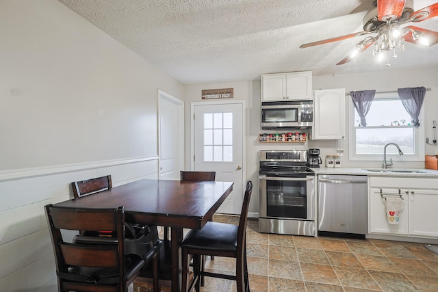 kitchen with white cabinetry, sink, a textured ceiling, and appliances with stainless steel finishes