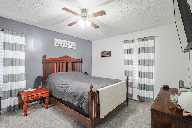 bedroom featuring ceiling fan, a textured ceiling, and carpet