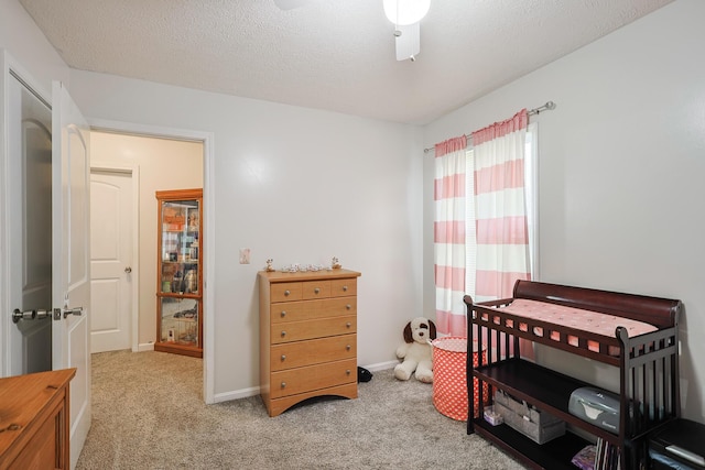 carpeted bedroom featuring a textured ceiling