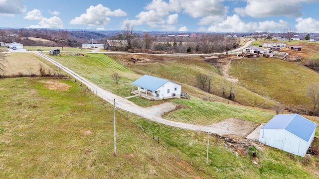 birds eye view of property with a rural view