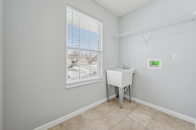 washroom featuring light tile patterned flooring and hookup for a washing machine