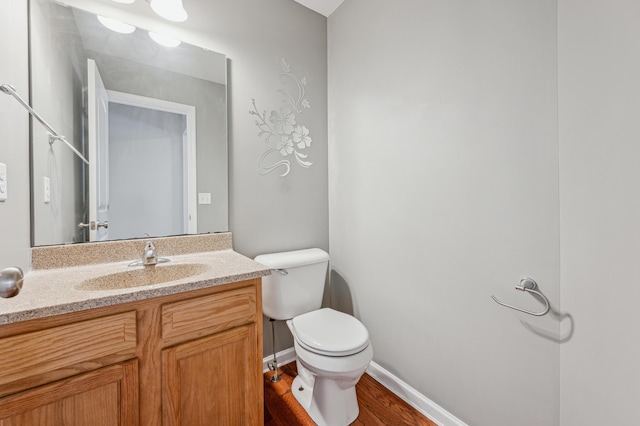 bathroom featuring vanity, wood-type flooring, and toilet