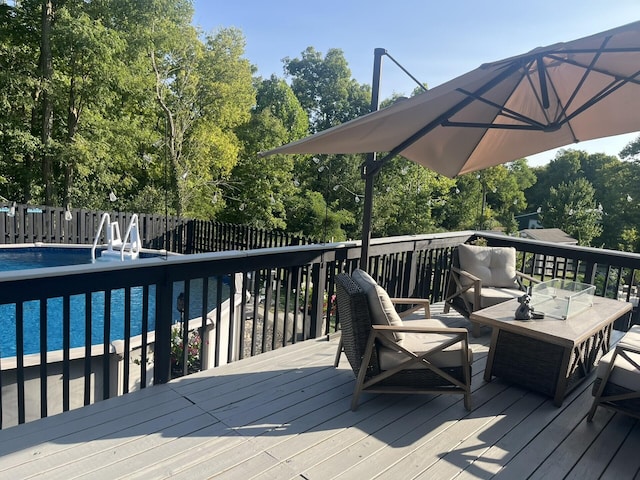 wooden terrace with a fenced in pool and an outdoor hangout area