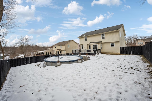 snow covered property featuring a deck