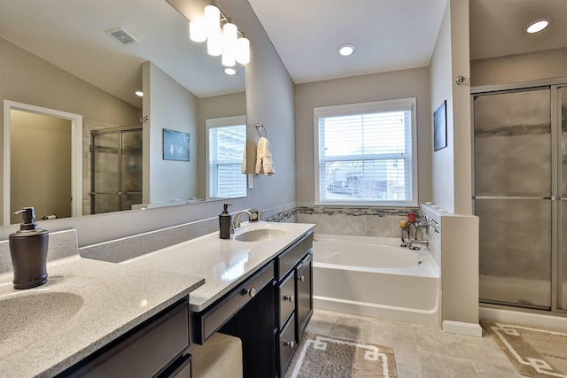 bathroom featuring tile patterned flooring, vanity, and separate shower and tub