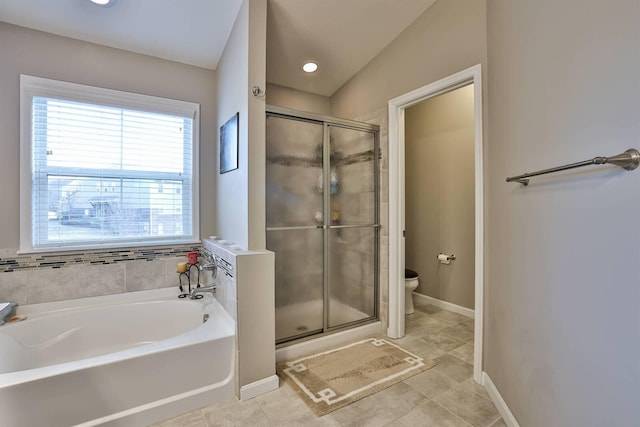 bathroom featuring tile patterned floors, shower with separate bathtub, and toilet